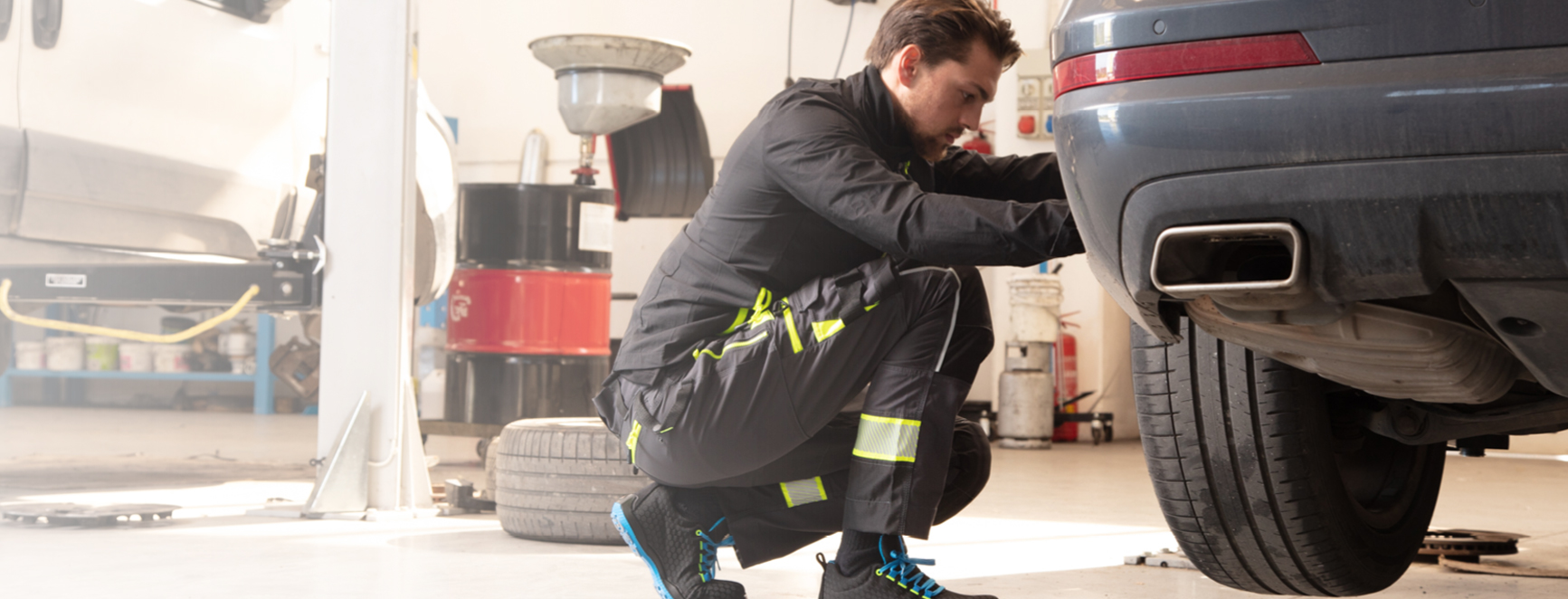 Mechanic working beside a vehicle in a workshop